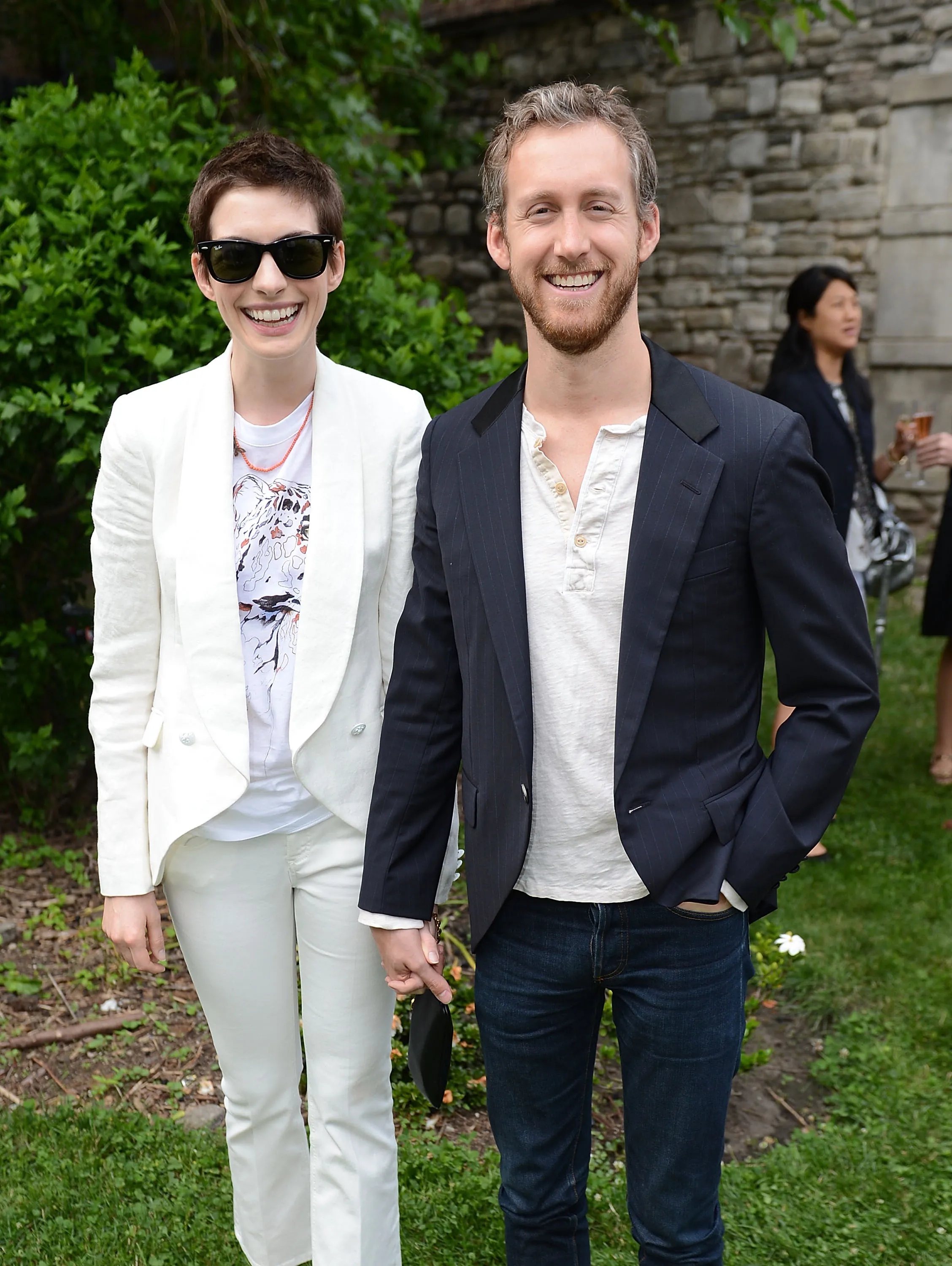 Anne Hathaway and Adam Shulman smiling at the Stella McCartney Spring 2012 Presentation.