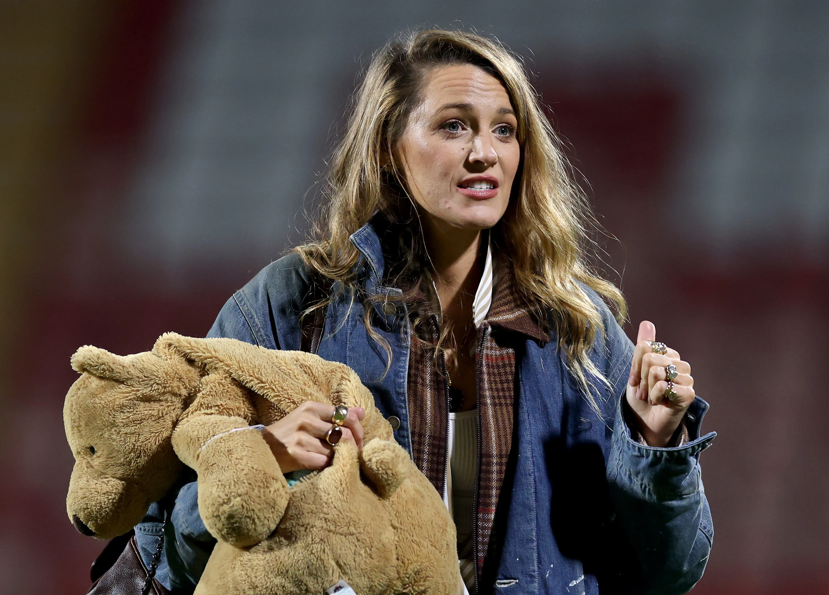 Actress Blake Lively holding a teddy bear.