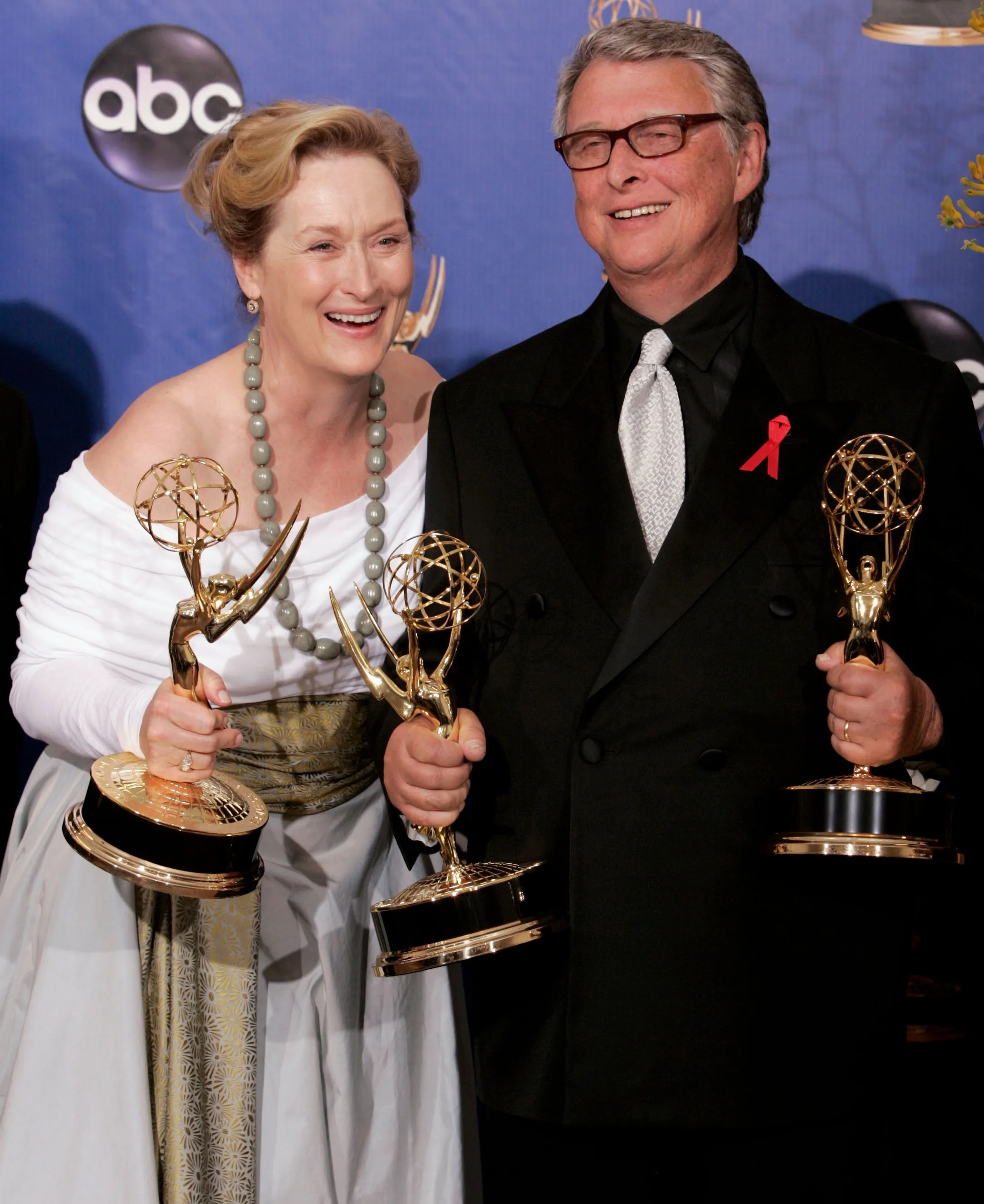 Meryl Streep and Mike Nichols smiling while holding their Emmys for "Angels in America."