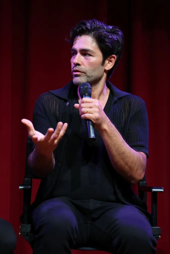 Adrian Grenier speaking into a microphone onstage at SXSW.