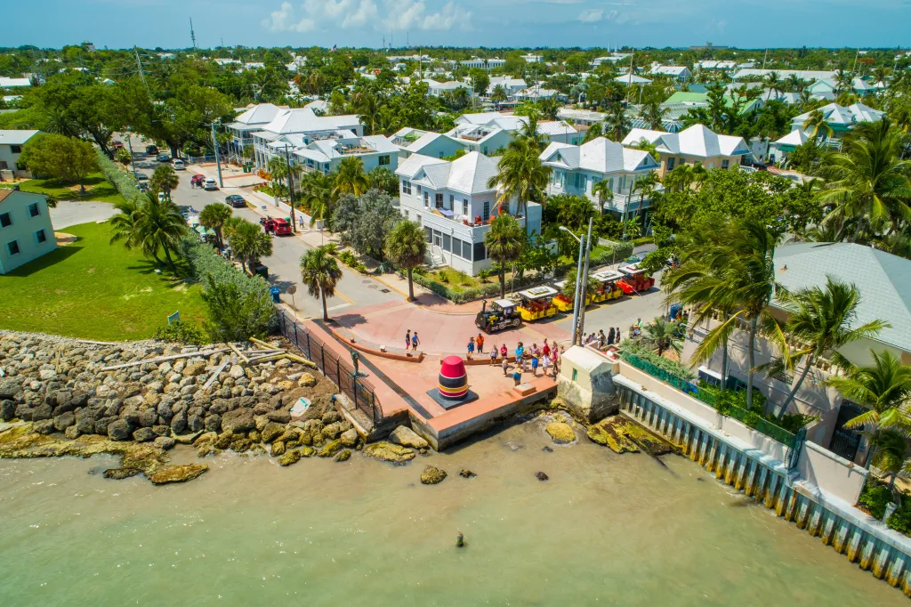 Aerial image of the Southernmost Point in Key West, Florida, with people waiting in line to see the buoy landmark.
