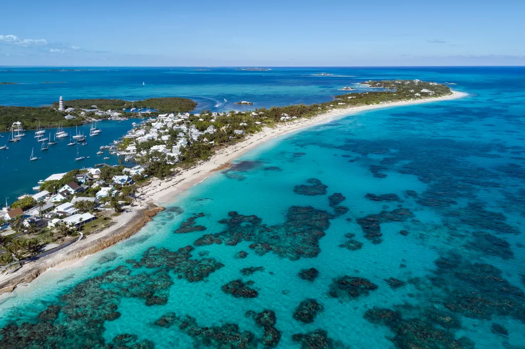 Aerial view of the harbour, lighthouse, and beach in Hope Town on Elbow Cay, Abaco.