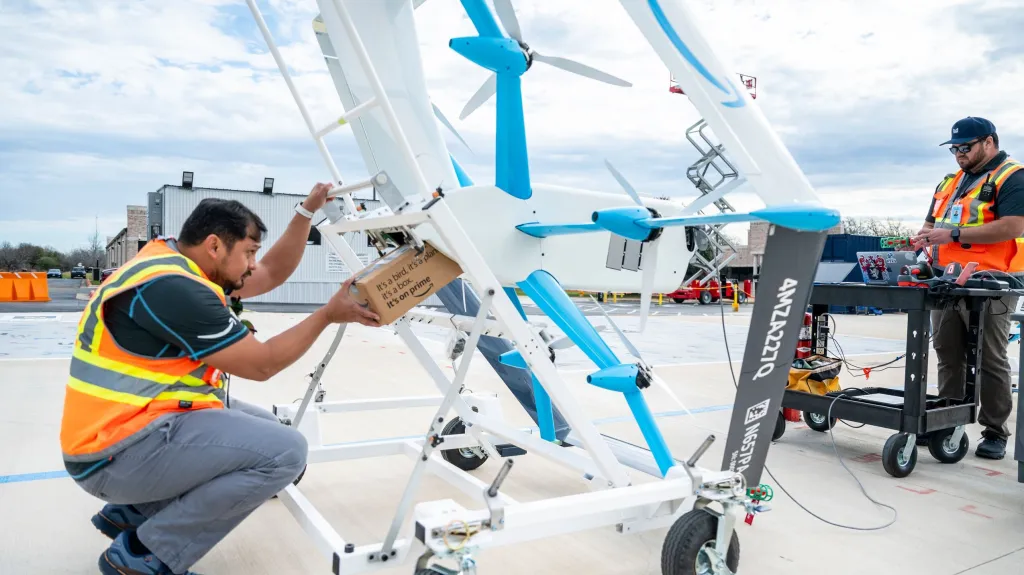 Amazon workers fine-tuning the drones. 