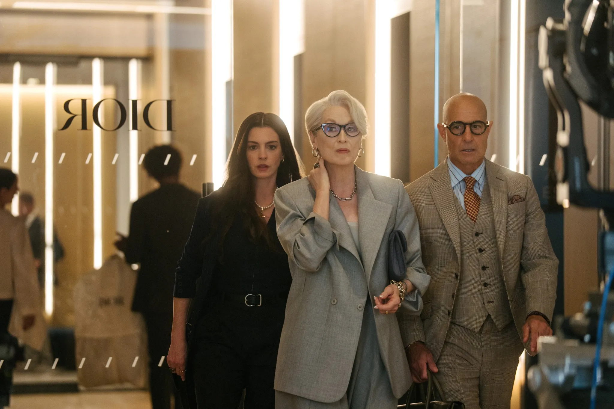 Anne Hathaway as Andy Sachs, Meryl Streep as Miranda Priestly, and Stanley Tucci as Nigel Kipling in The Devil Wears Prada 2.