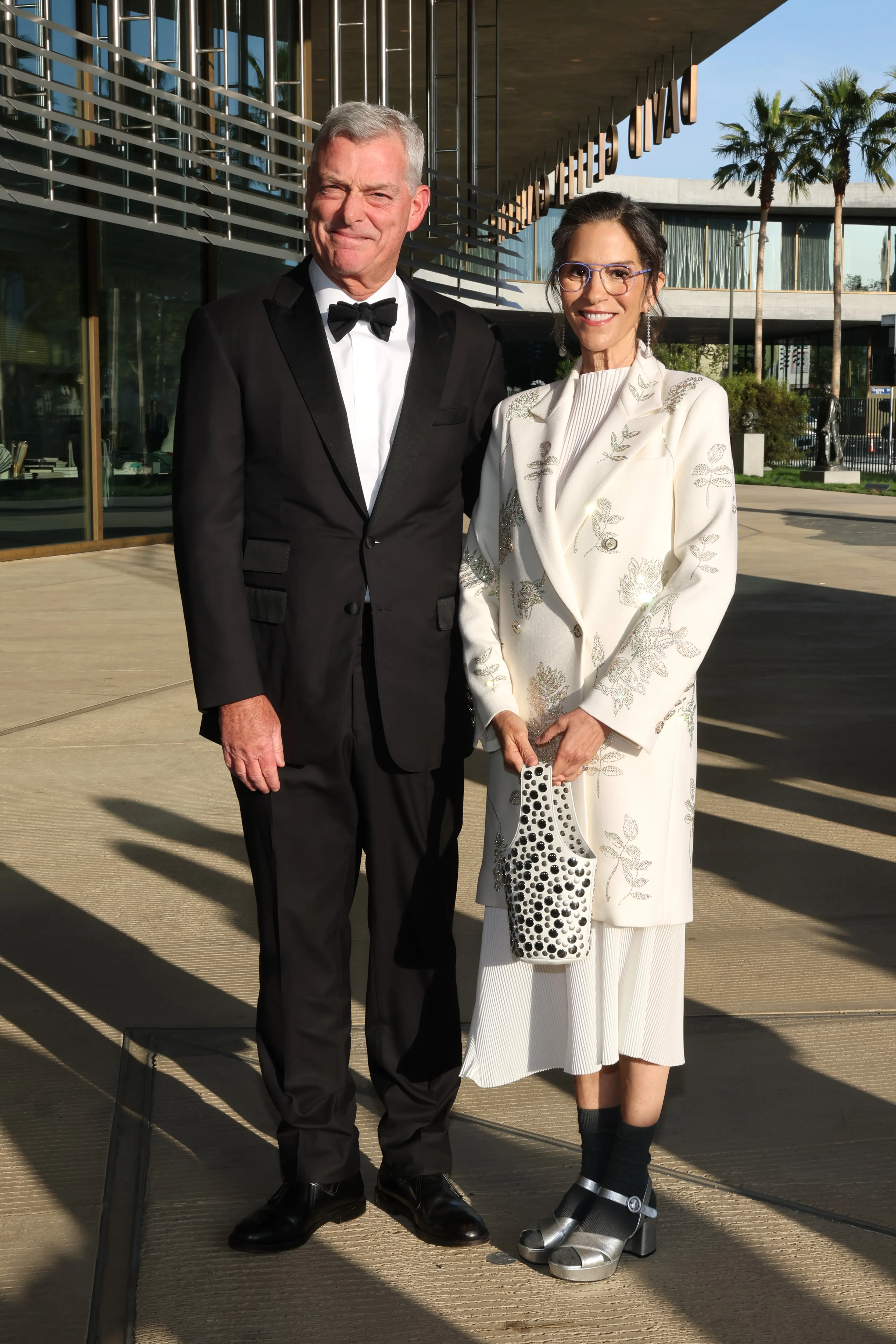Antony Ressler and Jami Gertz posing at LACMA's Opening Gala for The David Geffen Galleries.