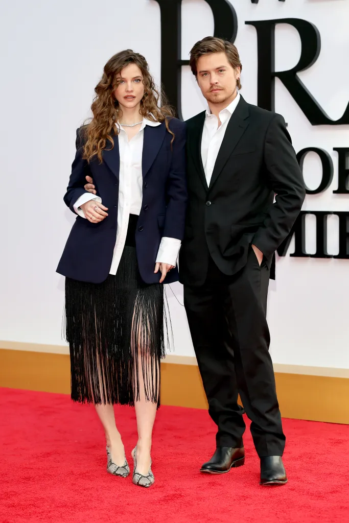Barbara Sprouse and Dylan Sprouse on a red carpet.