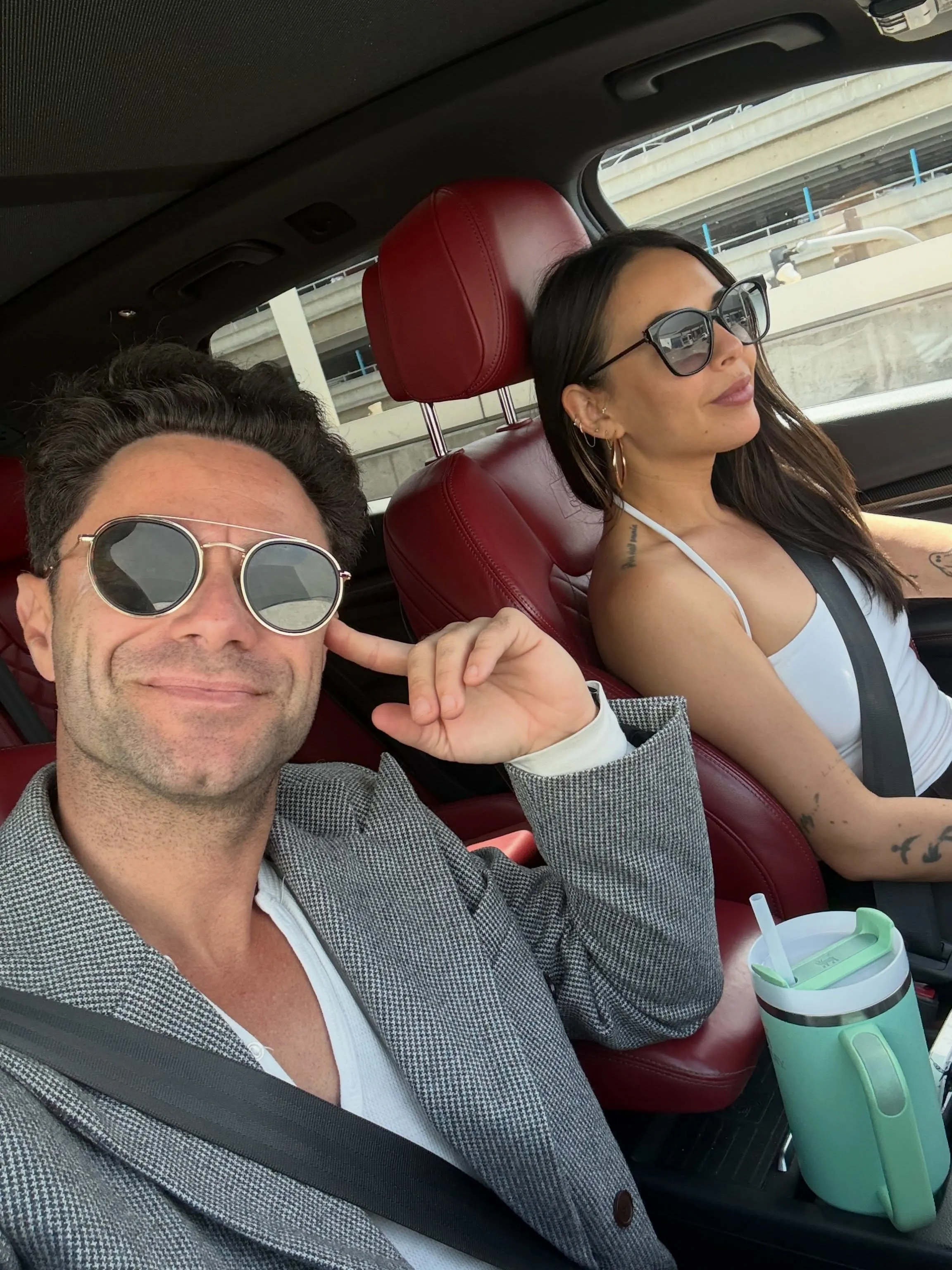 Sasha Farber and Janel Parrish in a car.