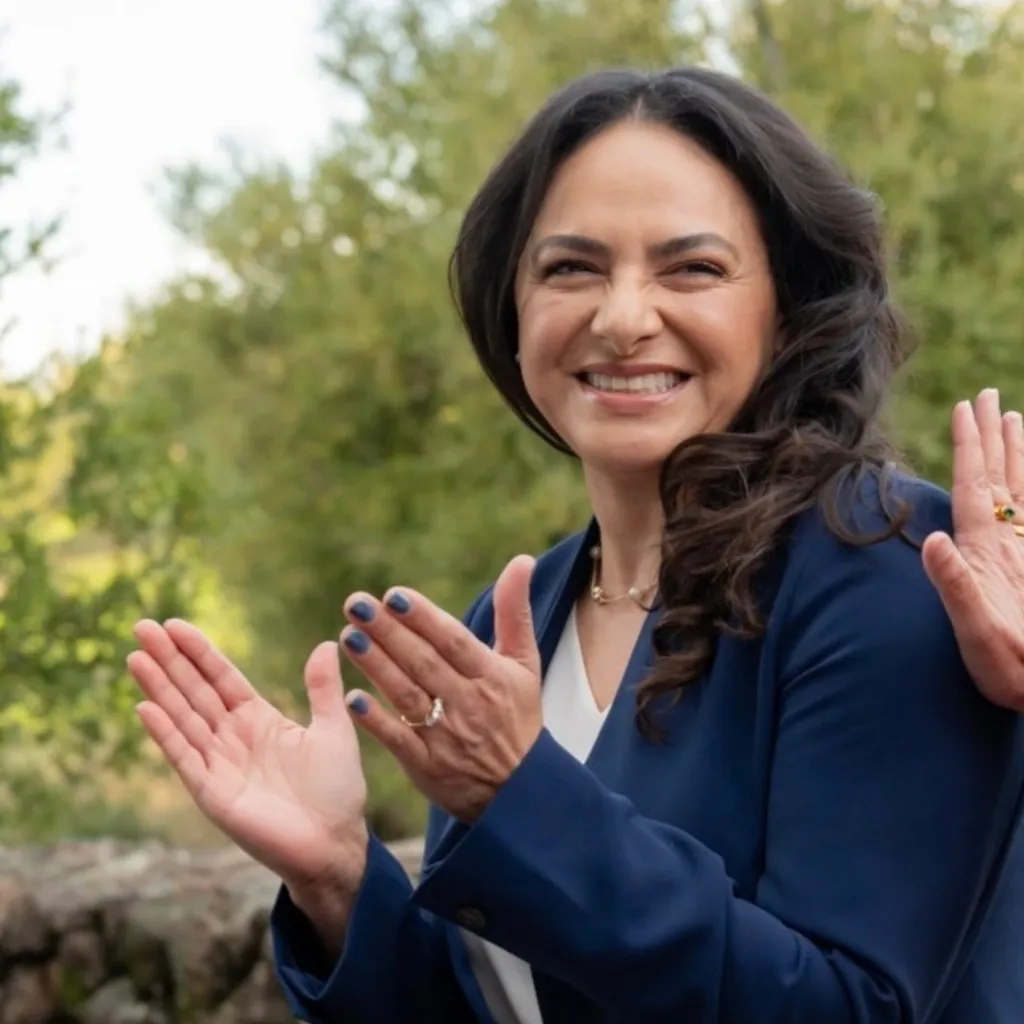 Belia Ramos clapping and smiling.