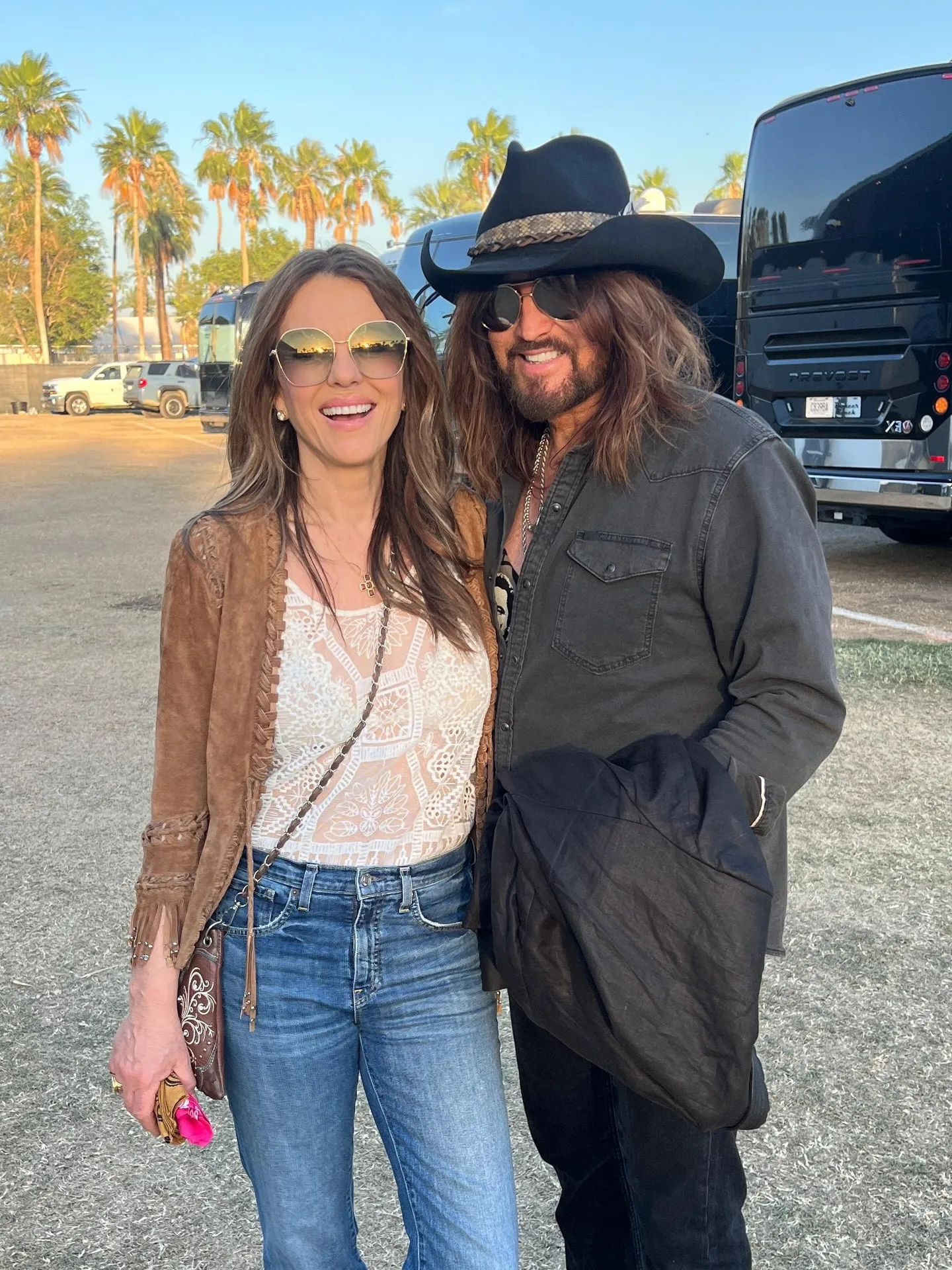 Elizabeth Hurley and Billy Ray Cyrus posing together.