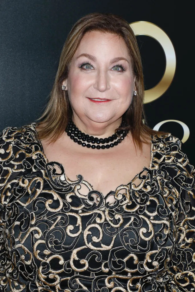 Headshot of Wendy Kaufman in a black and gold dress with a black beaded necklace.