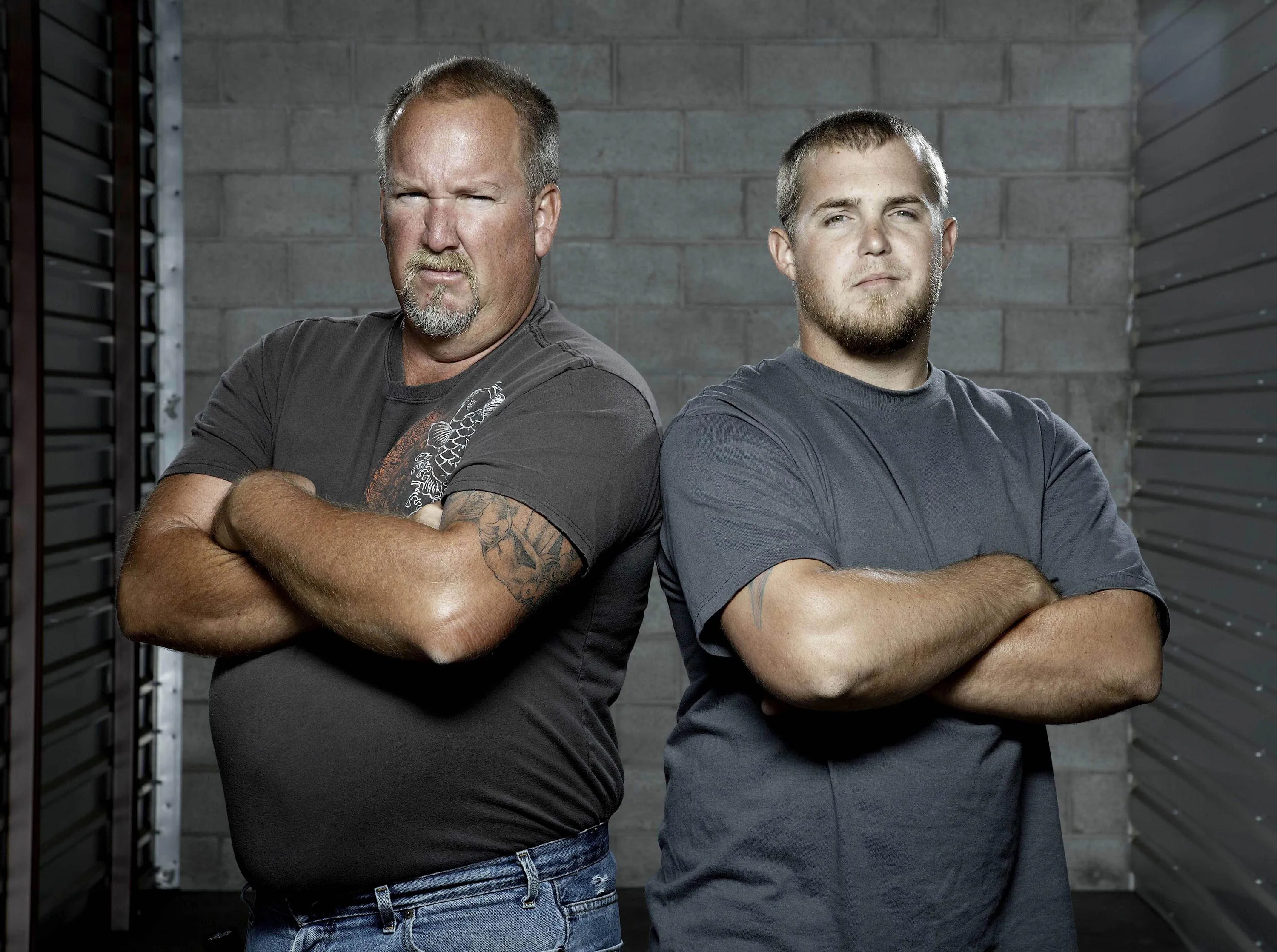 Darrell Sheets and Brandon Sheets from the TV series "Storage Wars" standing with their arms crossed.