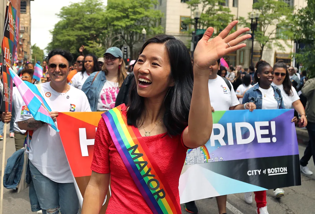 Boston Mayor Michelle Wu waves to the crowd as she marches in the parade.