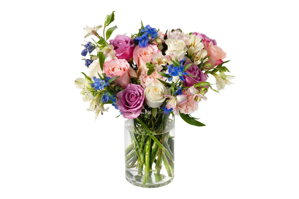 A bouquet of flowers in a glass vase from UrbanStems.
