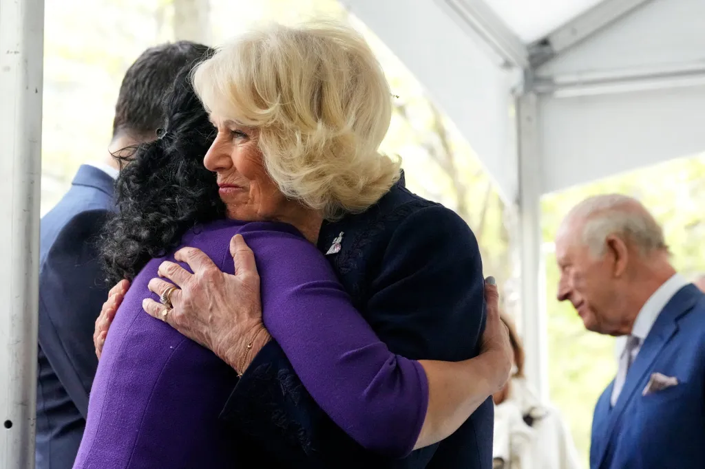 Britain's Queen Camilla embraces a family member of a 9/11 victim during a visit to the 9/11 Memoria