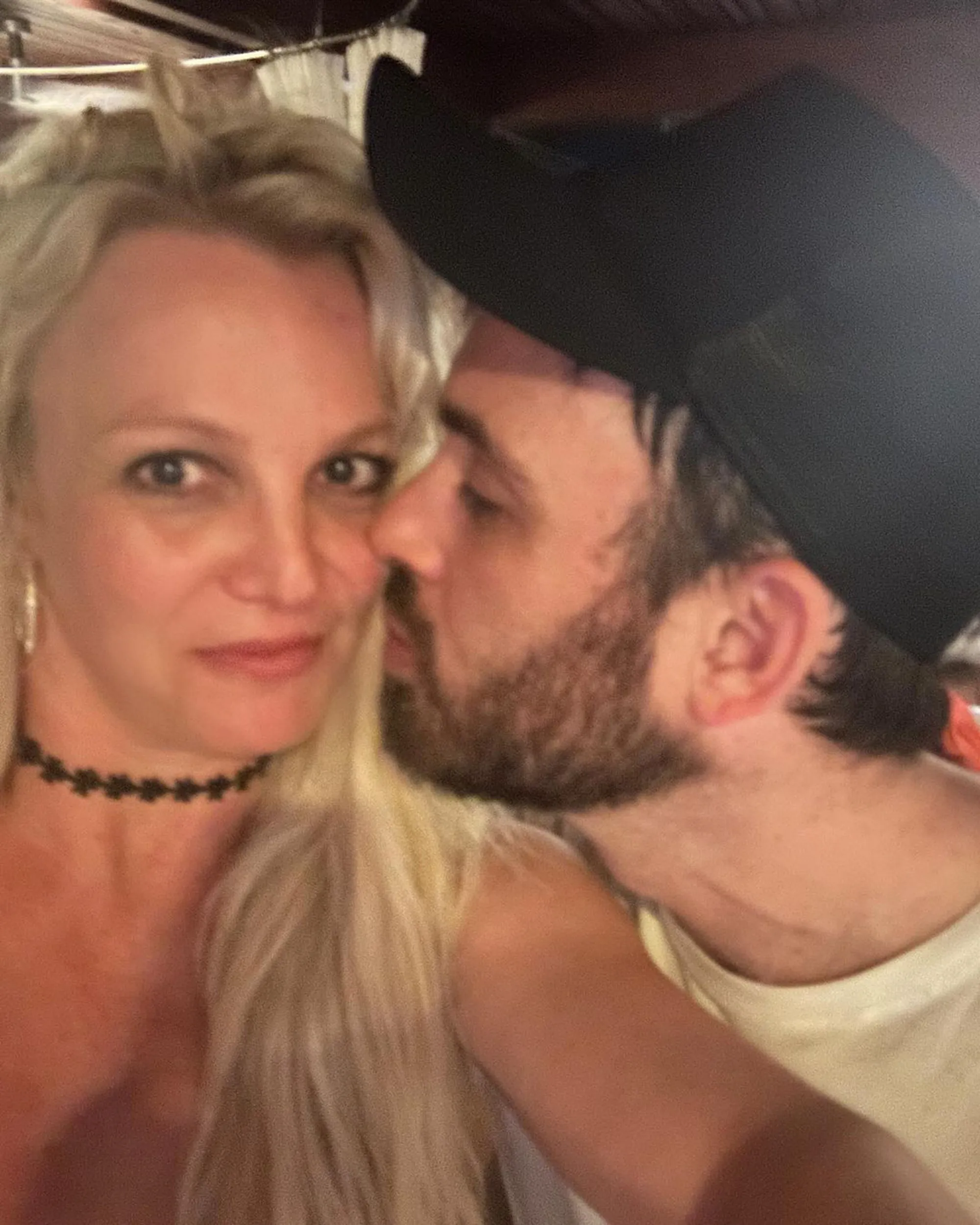 Britney Spears and her manager Cade Hudson pose closely together for a selfie, with Cade leaning in towards her cheek.