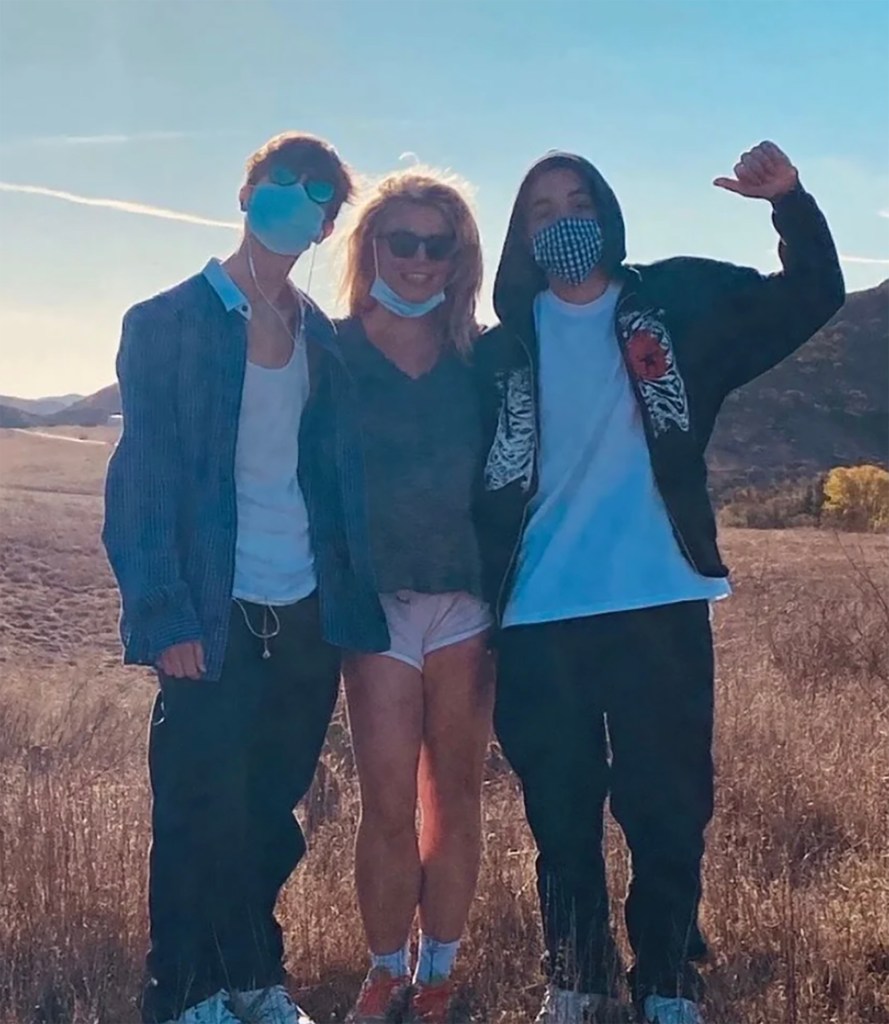 Britney Spears with her sons, Jayden and Preston Federline, wearing face masks outdoors.