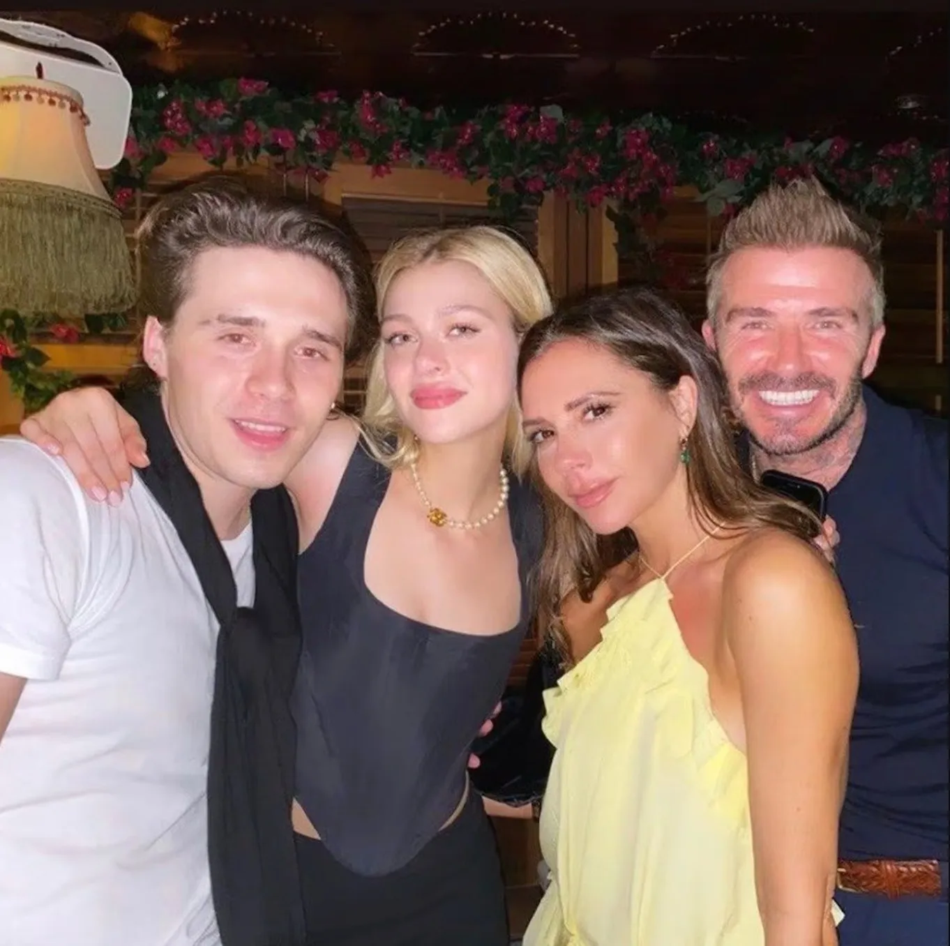 Brooklyn Beckham and Victoria Beckham with family.