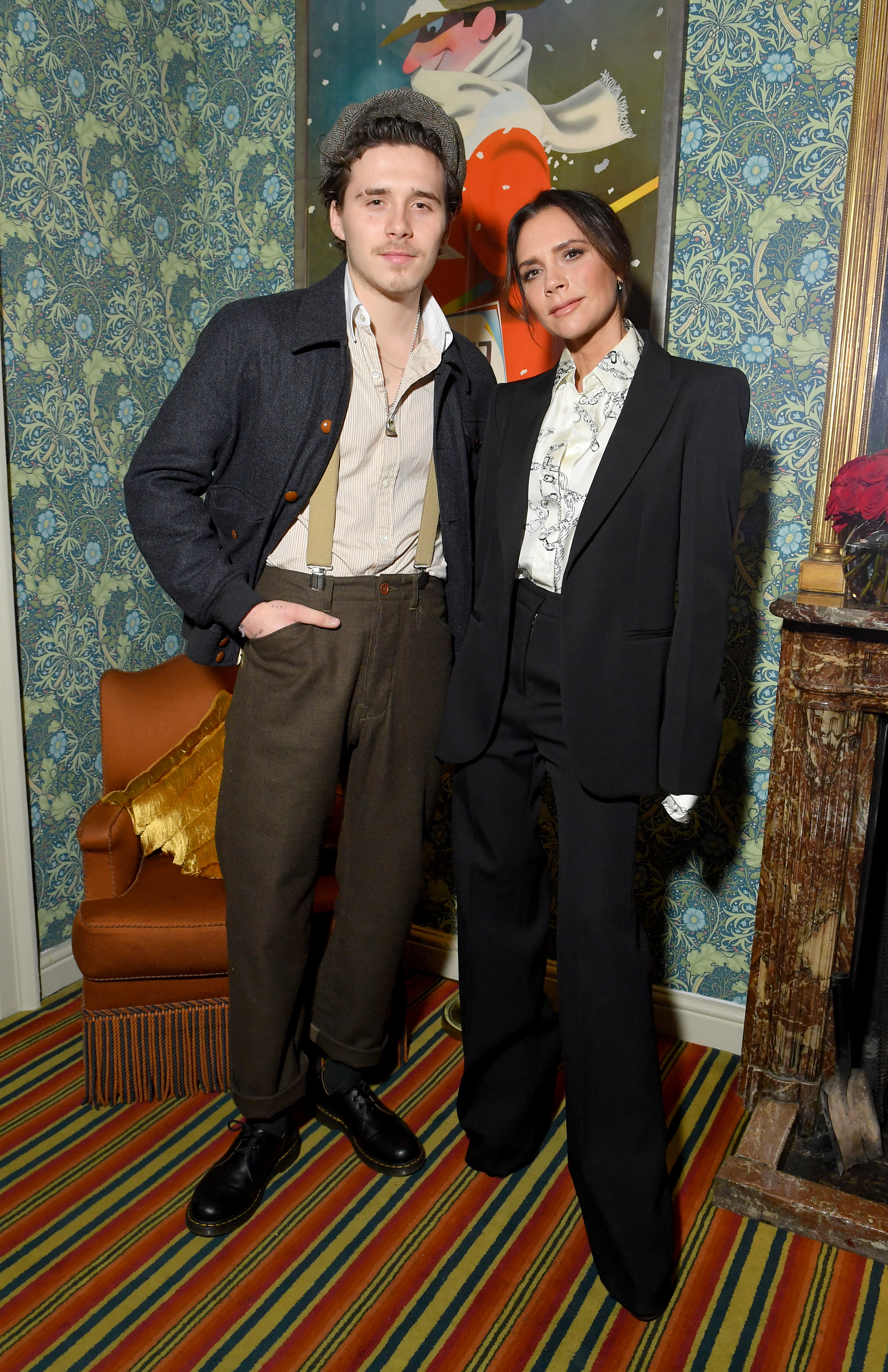 Brooklyn and Victoria Beckham posing together.