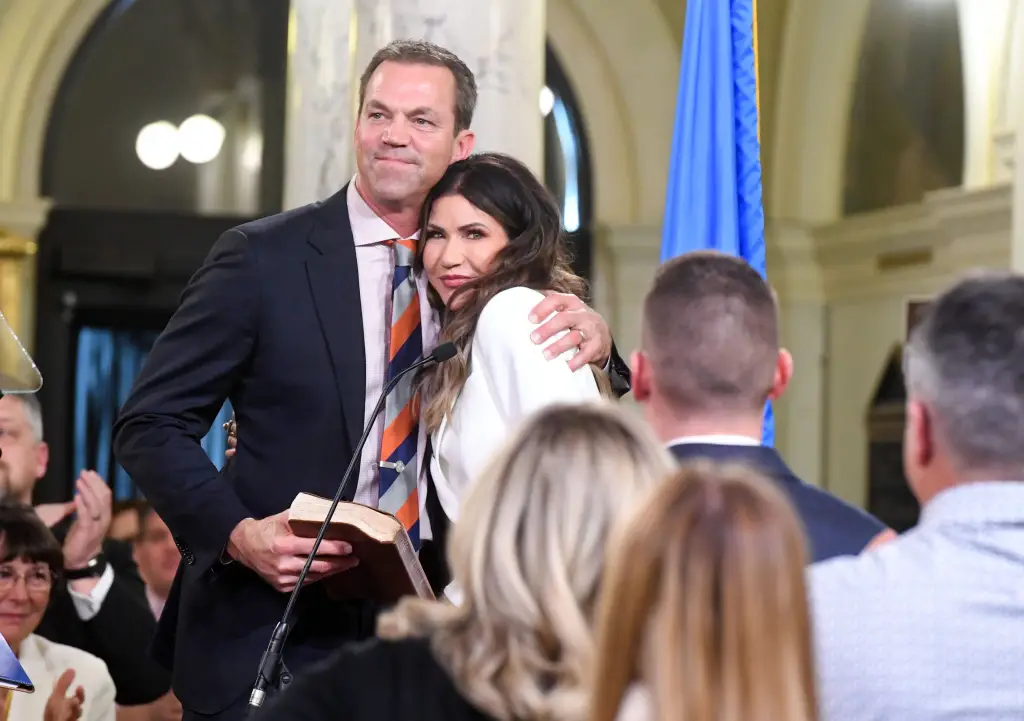 Bryon Noem hugs Governor Kristi Noem after her oath of office for her second term.