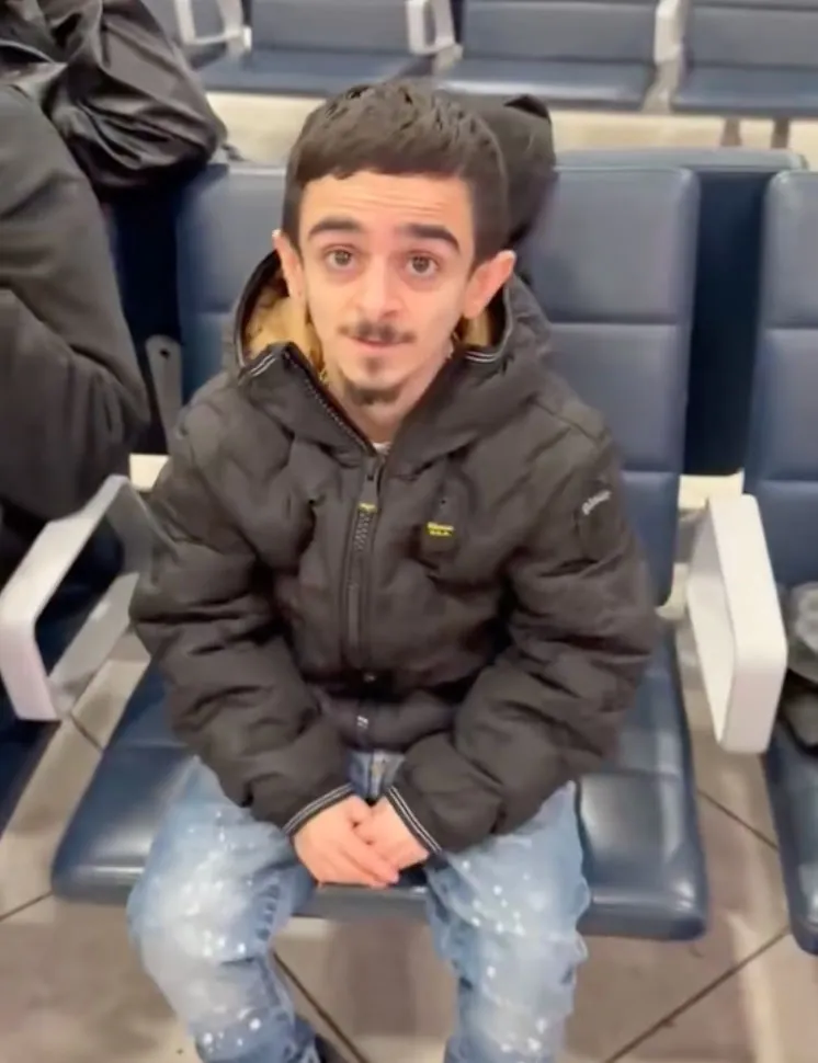 Small man at airport.
