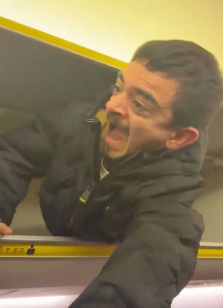 Small man in overhead bin.