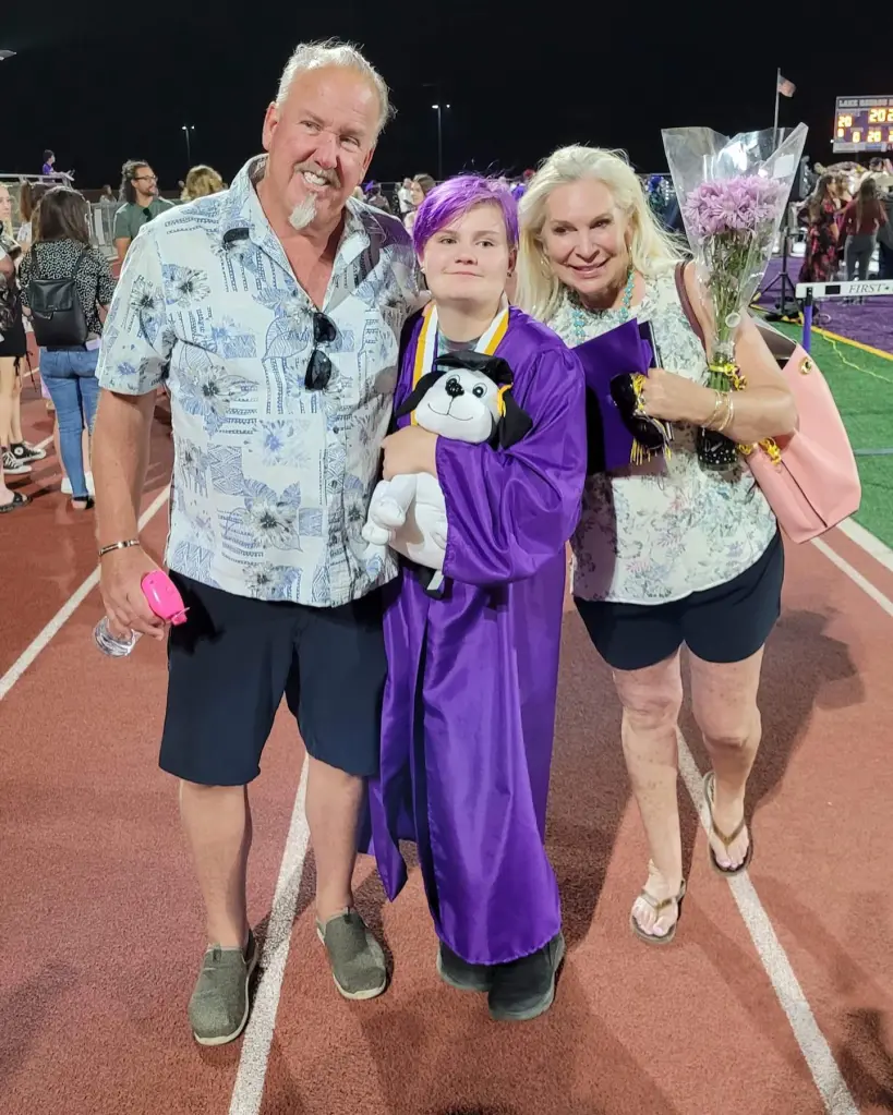 Darrell Sheets and his granddaughter, Zoie, in graduation attire with another woman.
