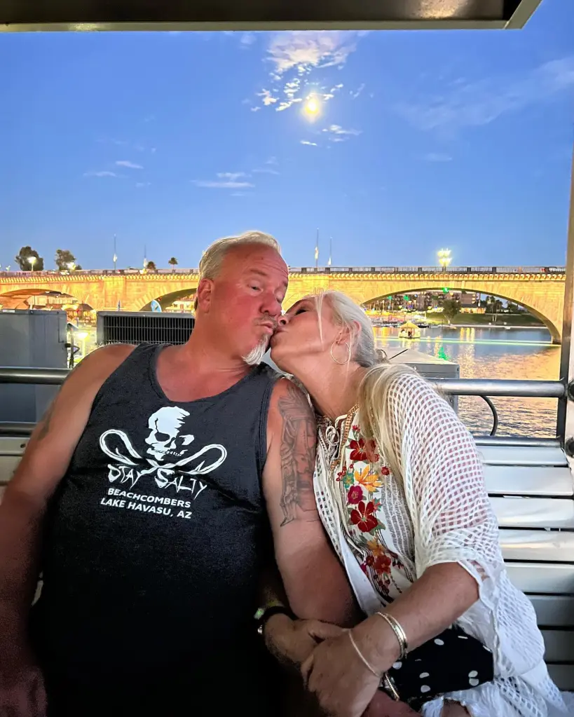 Darrell Sheets and Kimber Wuerfel kissing on a boat at Lake Havasu.