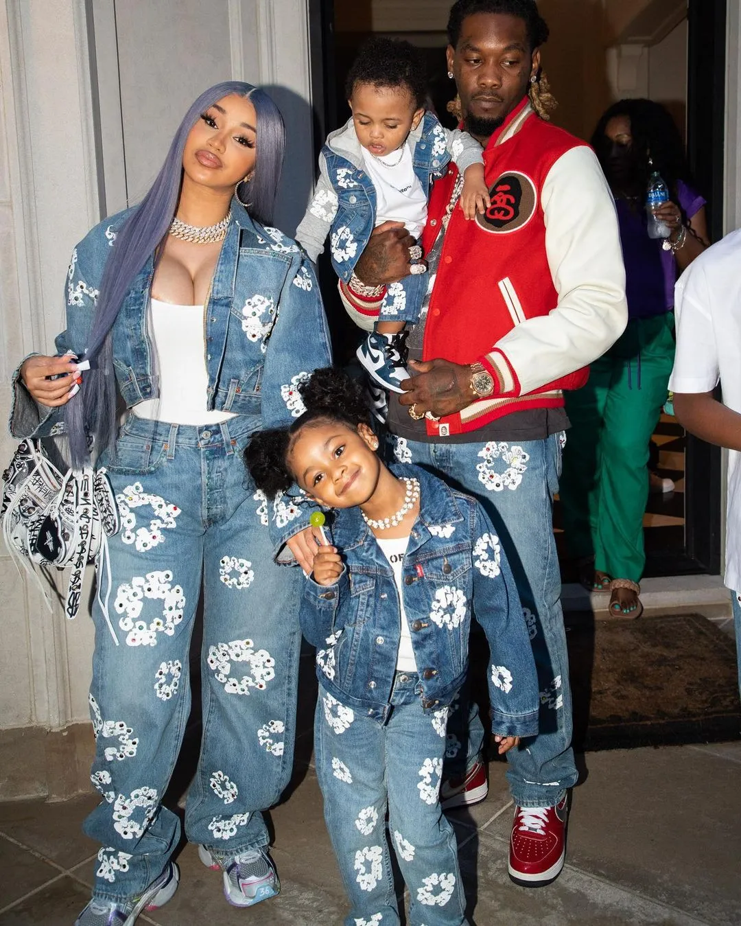 Cardi B, Offset, and their two children pose together wearing matching denim outfits.