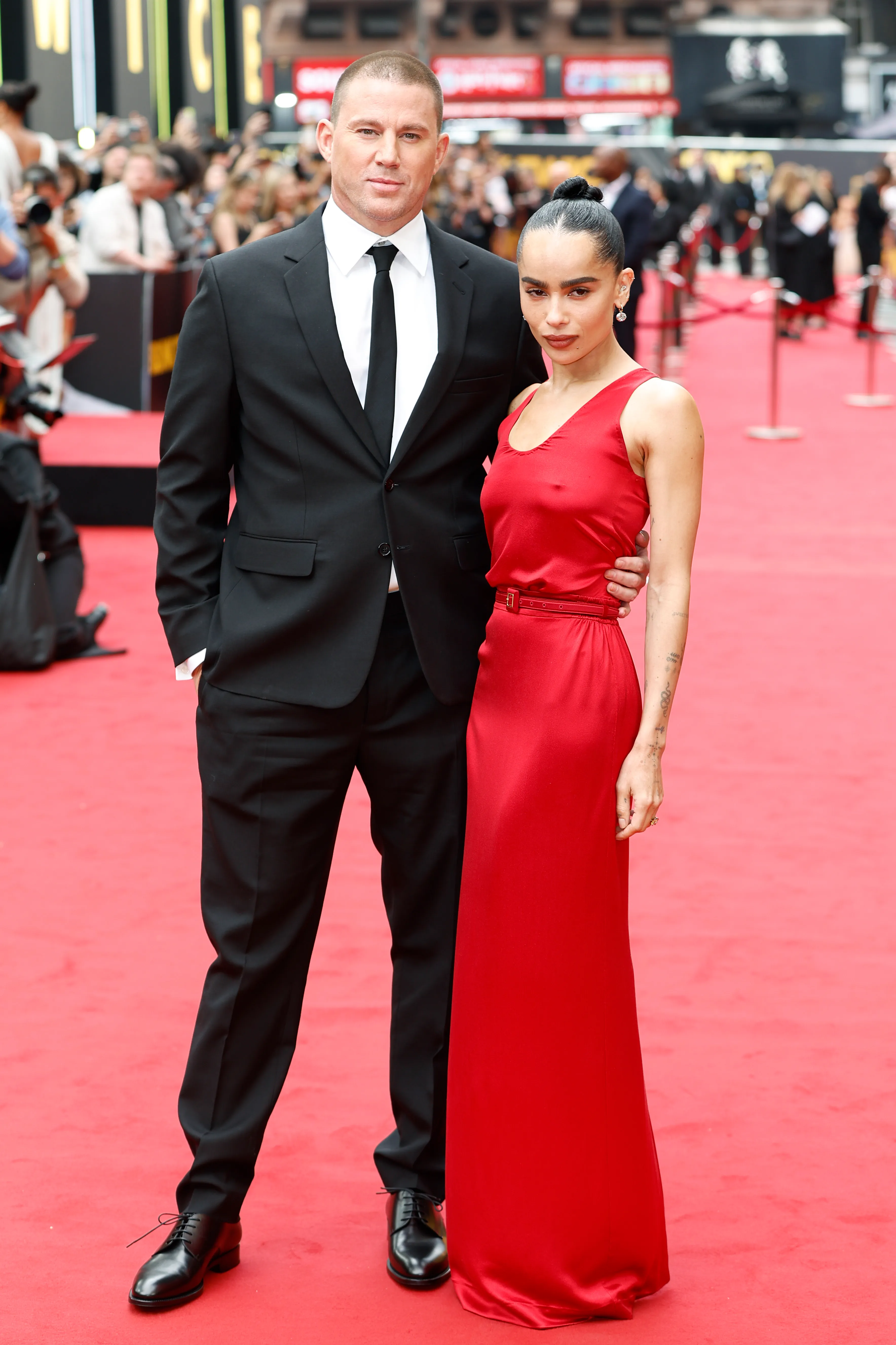 Channing Tatum in a black suit with Zoë Kravitz in a red dress.