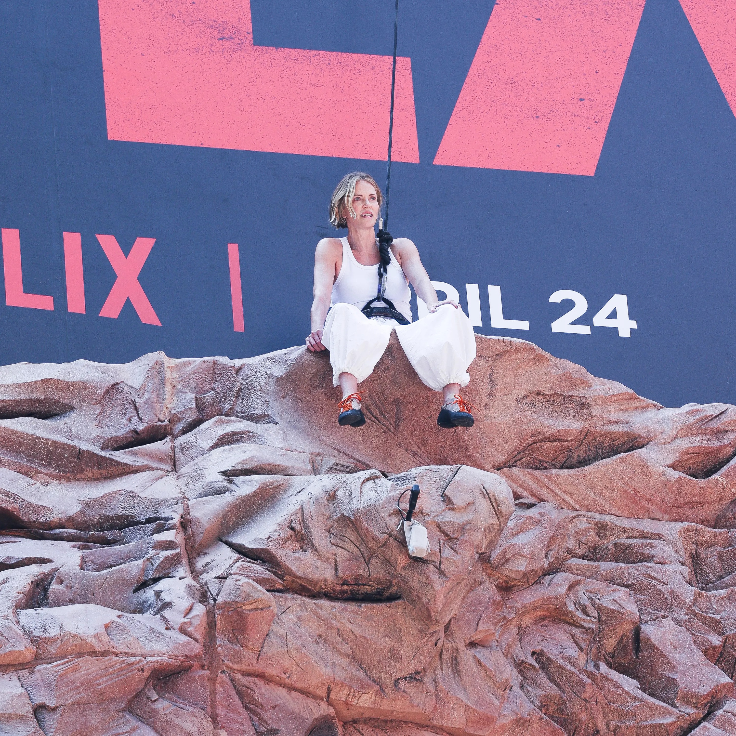 Charlize Theron is seen after climbing a wall to promote her new Netflix movie "Apex" 