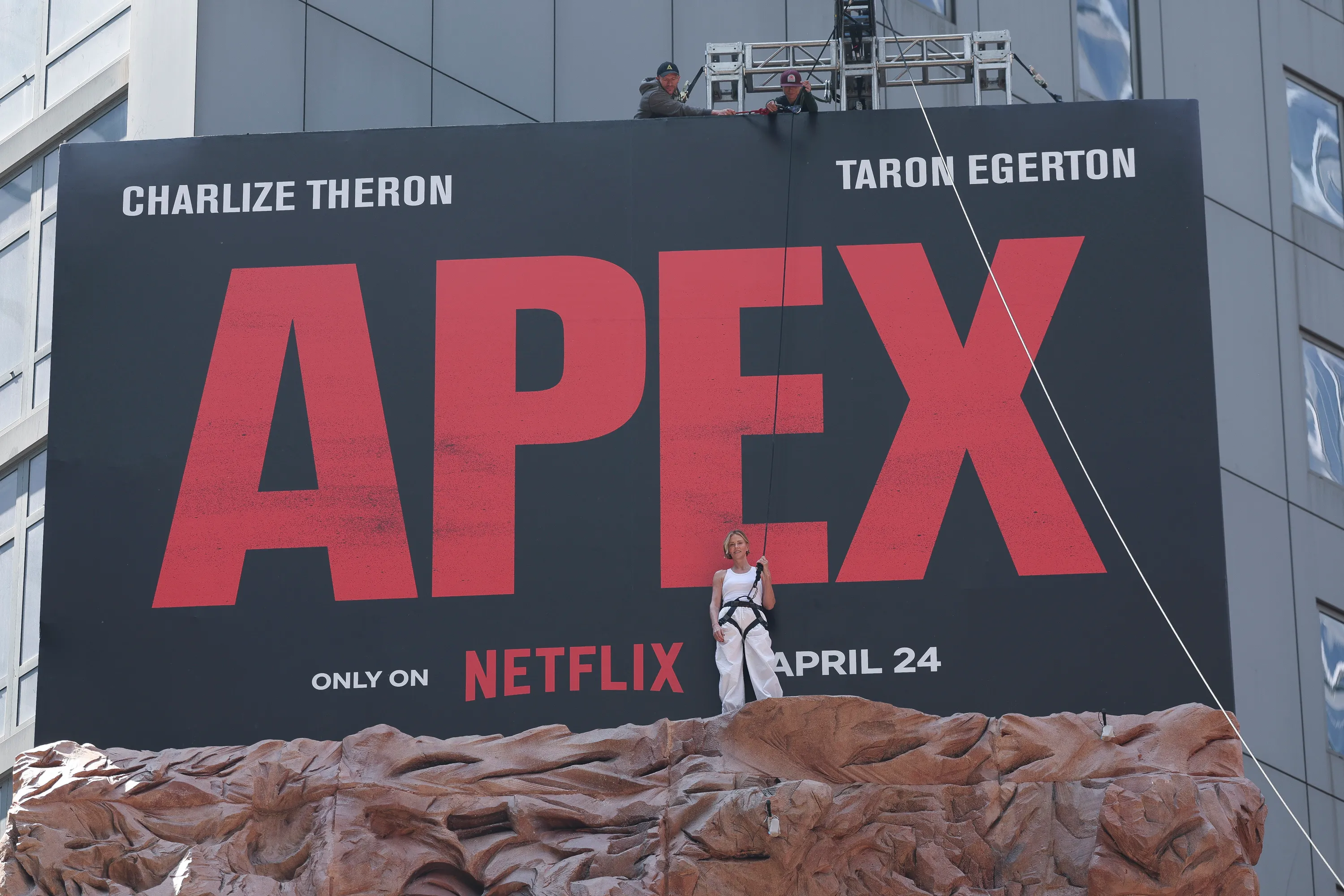 Charlize Theron is seen after climbing a wall to promote her new Netflix movie "Apex" 
