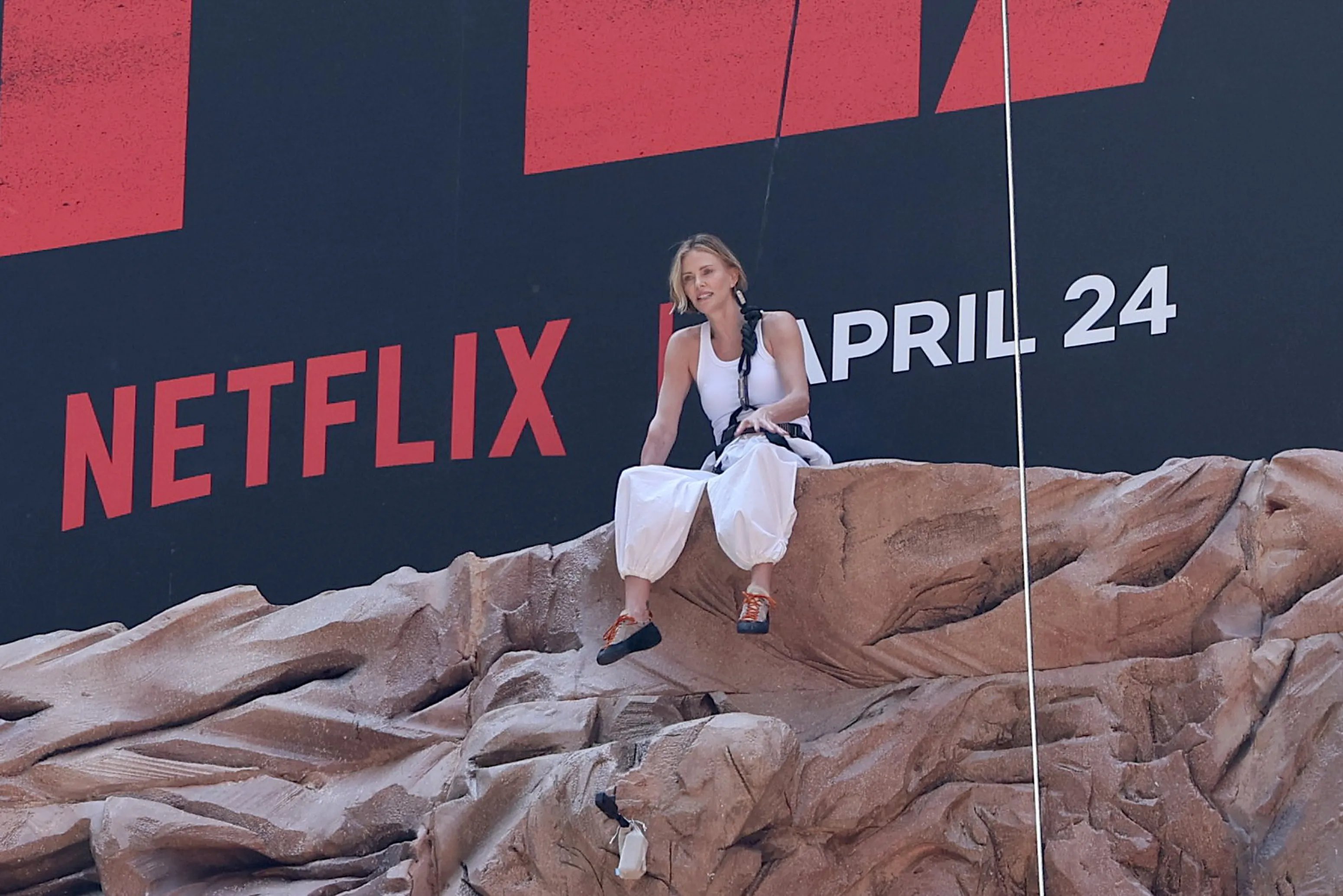 Charlize Theron is seen after climbing a wall to promote her new Netflix movie "Apex" 