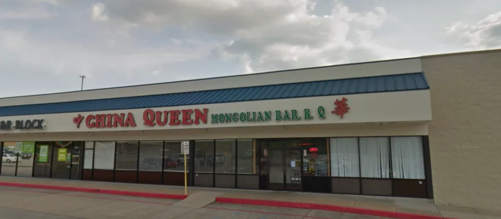 The storefront of the China Queen Mongolian Bar. B. Q. restaurant, with a red "OPEN" sign in the window.