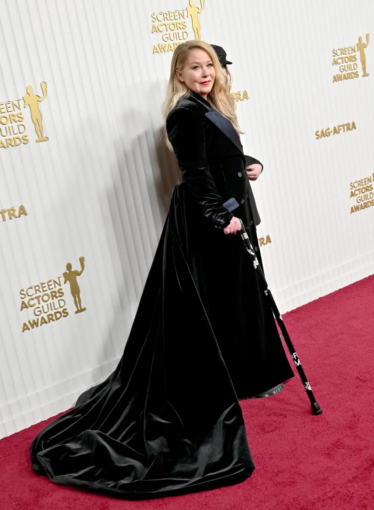 Christina Applegate in a black velvet gown with a long train and holding a cane at the Screen Actors Guild Awards.
