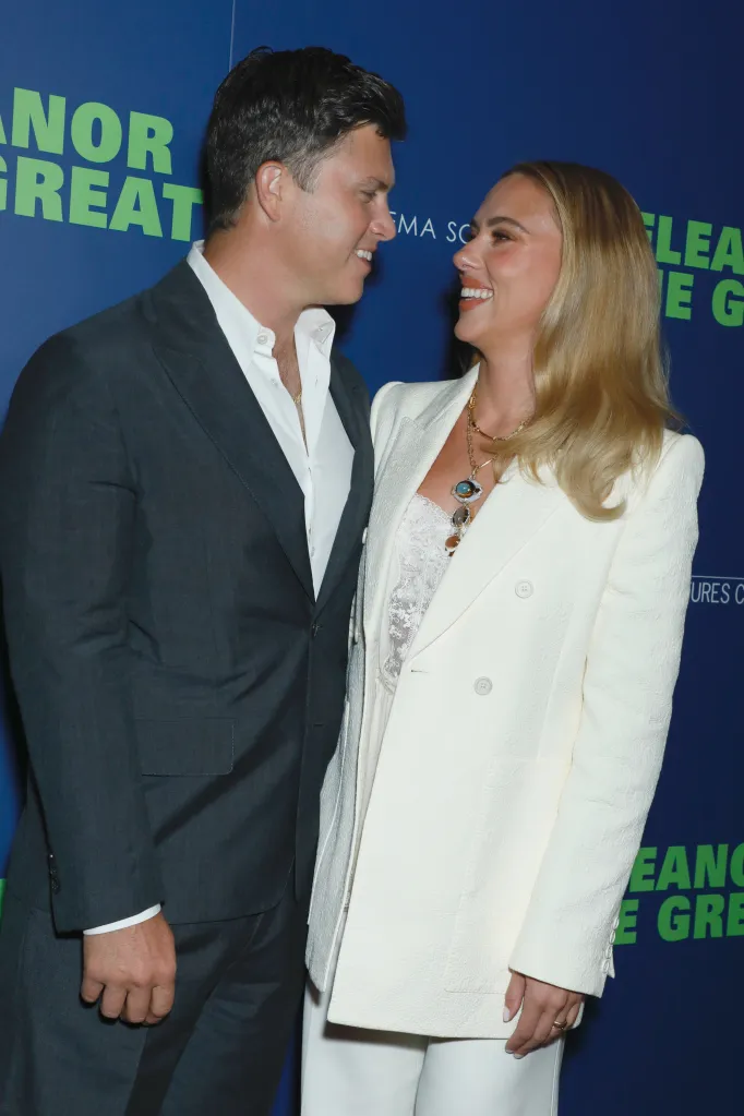 Colin Jost and Scarlett Johansson smiling at each other at the "Eleanor the Great" premiere.
