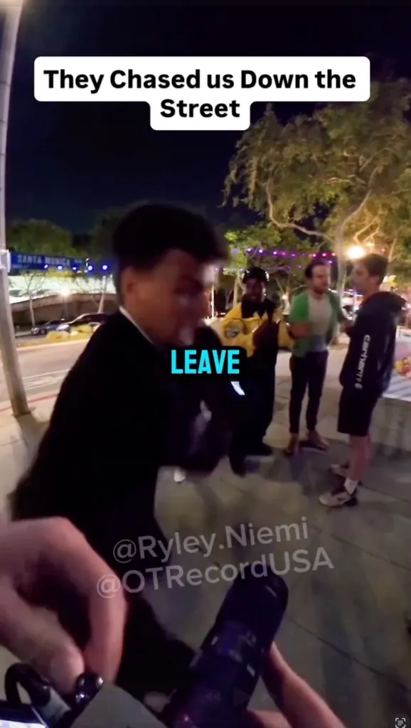 A blurred image of a man in a suit gesturing with the word "LEAVE" on his chest, with three men in the background and text that reads "They Chased us Down the Street."