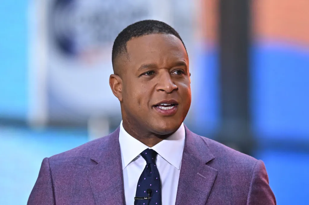 Craig Melvin, wearing a purple suit jacket and polka-dotted tie, speaks on the NBC Today Show Citi Concert Series.