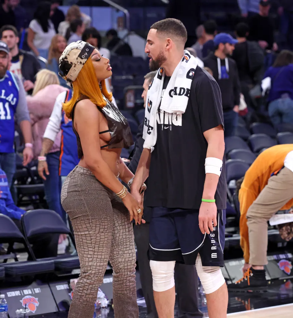 Megan Thee Stallion holds hands and talks with Dallas Mavericks guard Klay Thompson.