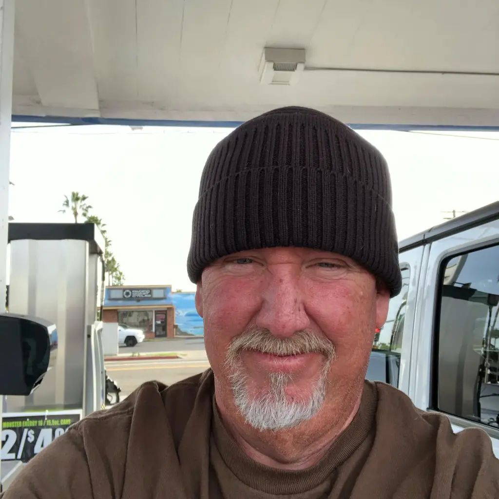Darrell Sheets in a beanie at a gas station.