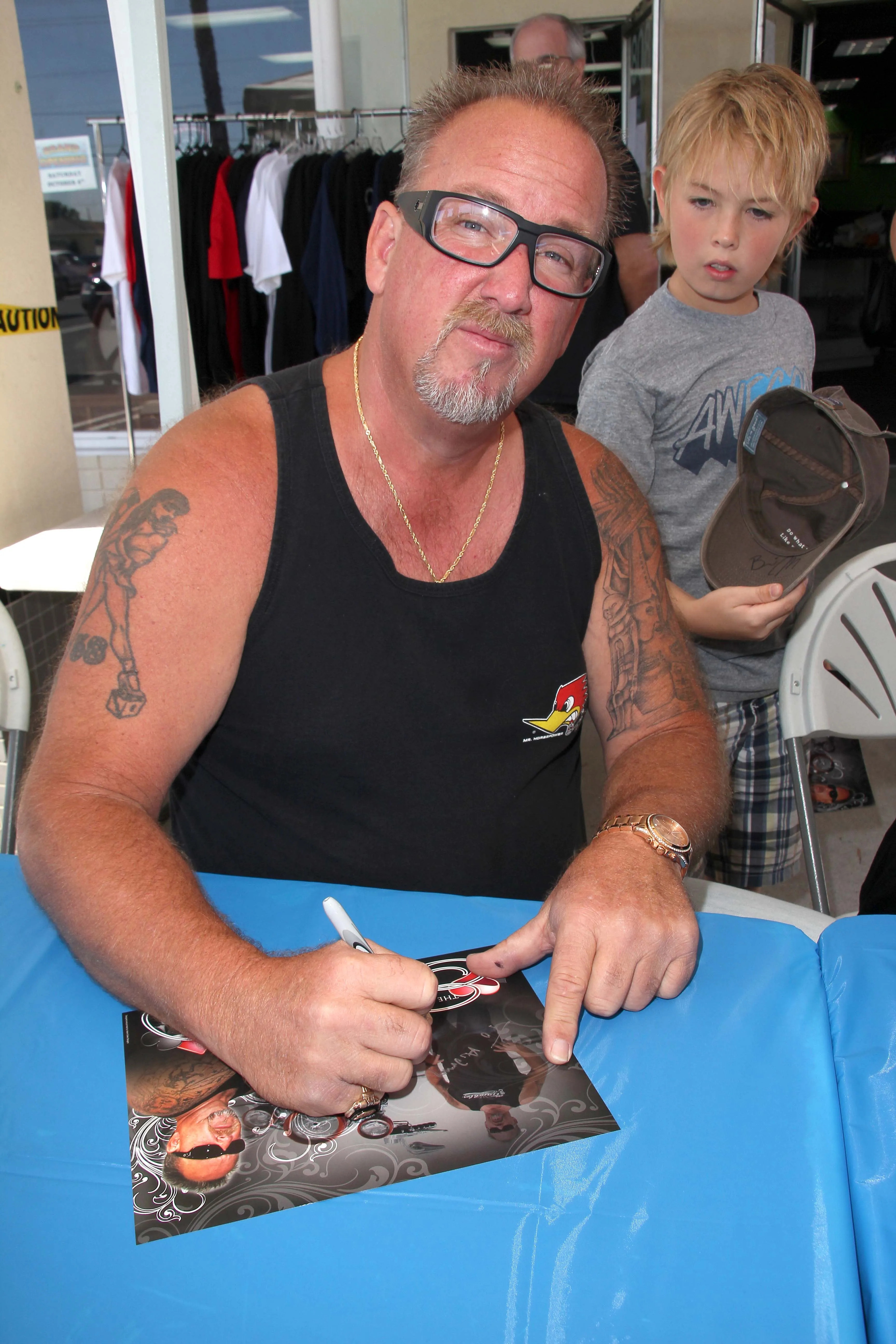 Darrell Sheets signing an autograph at the grand opening of the Now and Then Secondhand Store.