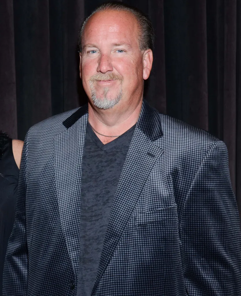 Darrell Sheets wearing a houndstooth blazer and a v-neck t-shirt.