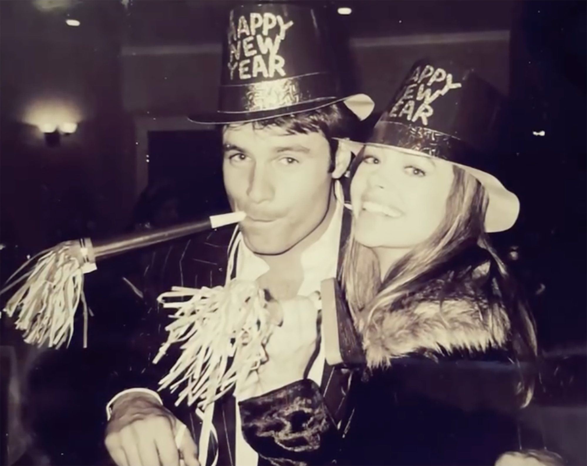 Denise Richards and Patrick Muldoon wearing "Happy New Year" hats.