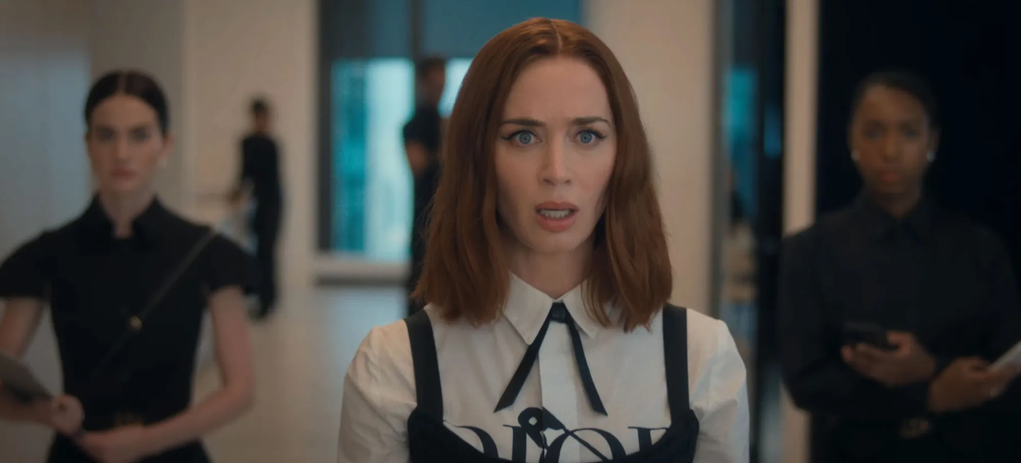 Emily Blunt as Miranda's former assistant, Emily, with a surprised expression in a scene from 