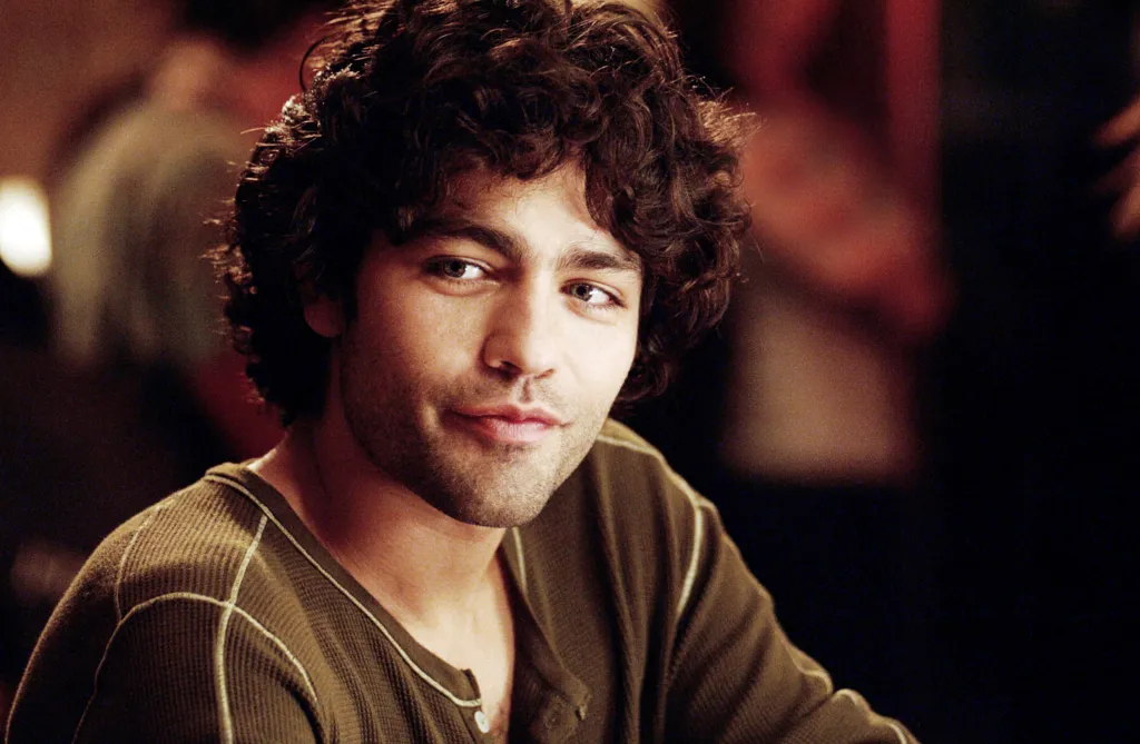 Adrian Grenier as Nate Cooper from The Devil Wears Prada, smiling in a green shirt.