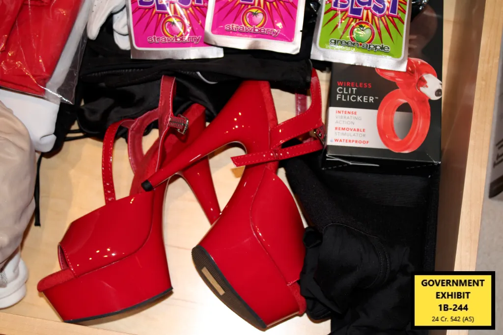 Red high-heeled platform shoes, lubricant packets, and a "Wireless Clit Flicker" sex toy.