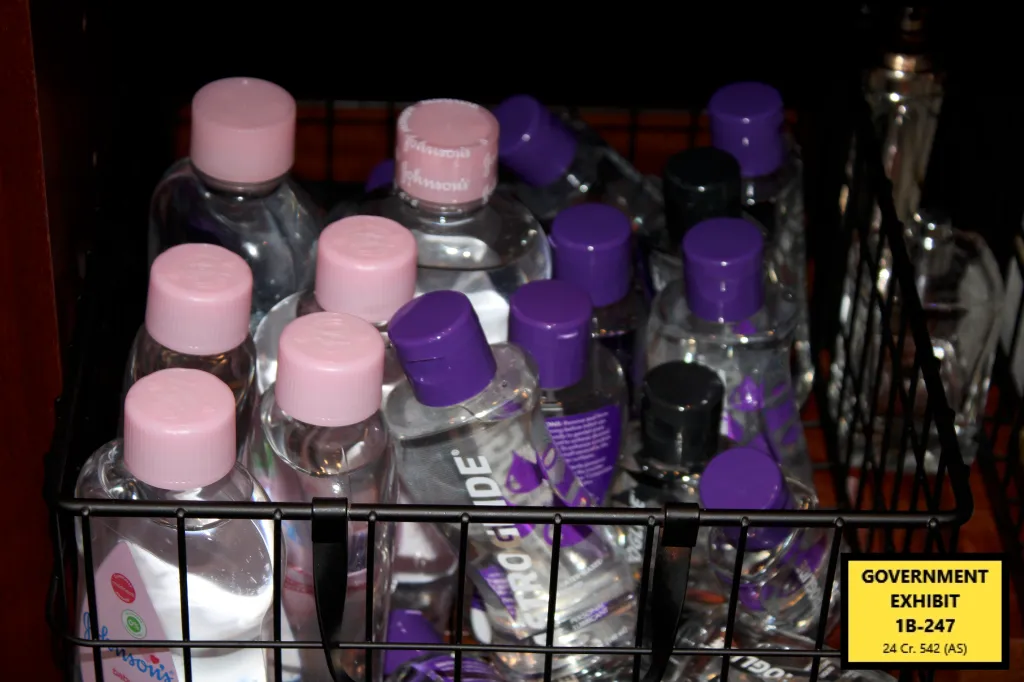 A wire basket containing bottles of Johnson's Baby Oil and Astroglide personal lubricant.