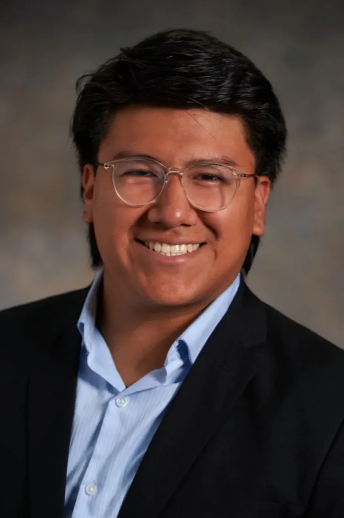 Diego Bollo smiling for a professional headshot.