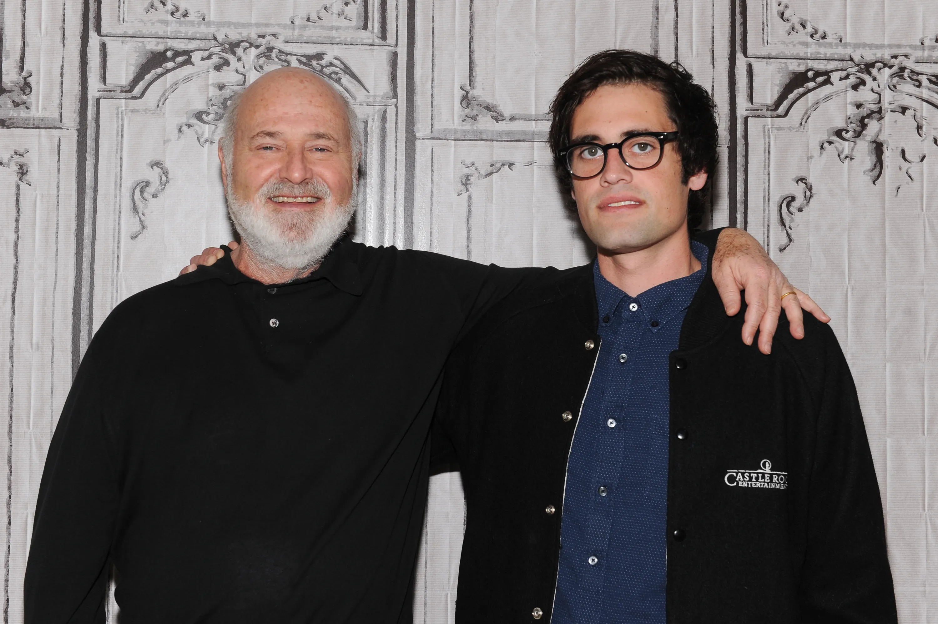 Director Rob Reiner and his son Nick Reiner with arms around each other.