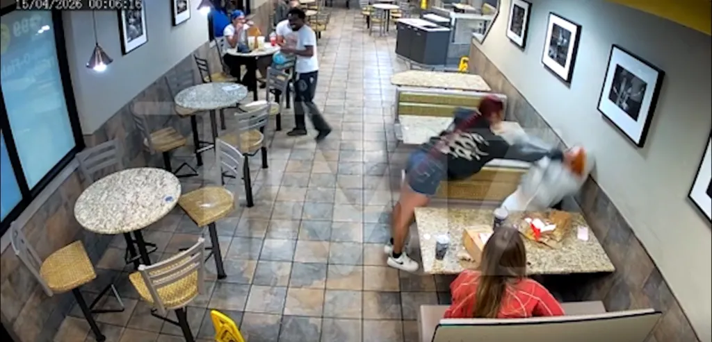 Video still of a woman slapping another person at a McDonald's.