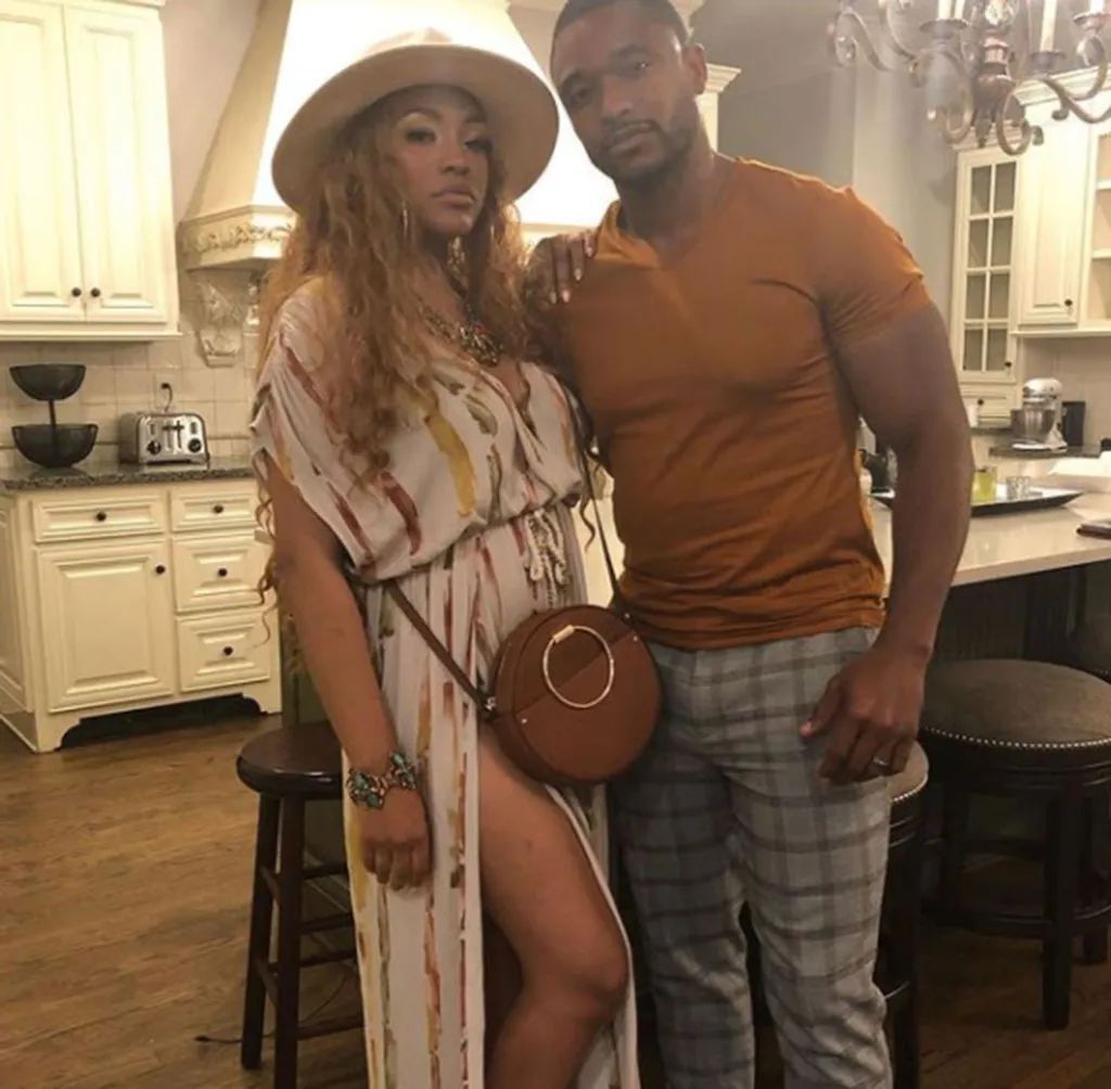 Drew Sidora and Ralph Pittman posing in a kitchen.